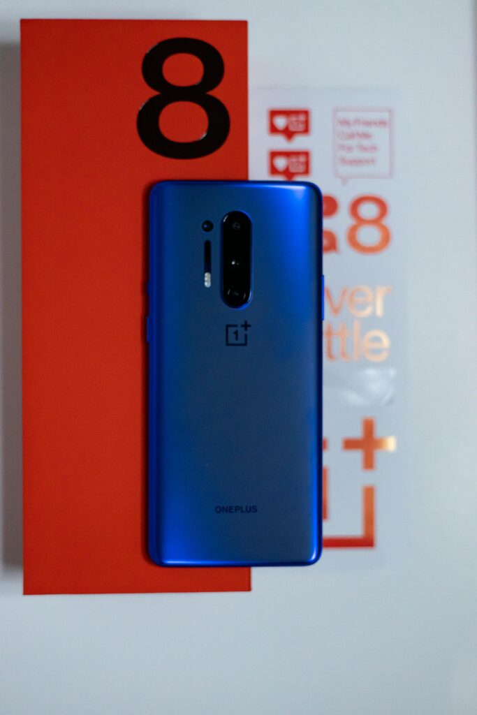 Close-up shot of OnePlus 8 Pro in vibrant blue, featuring packaging and design.
