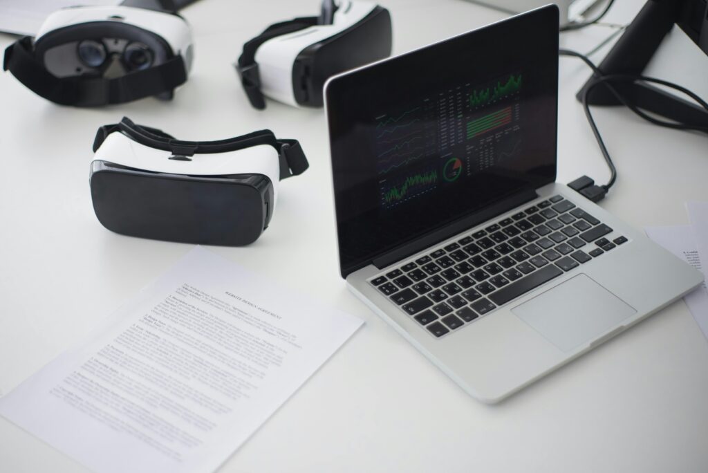 Modern workspace featuring laptop and VR headsets, ideal for tech themes.